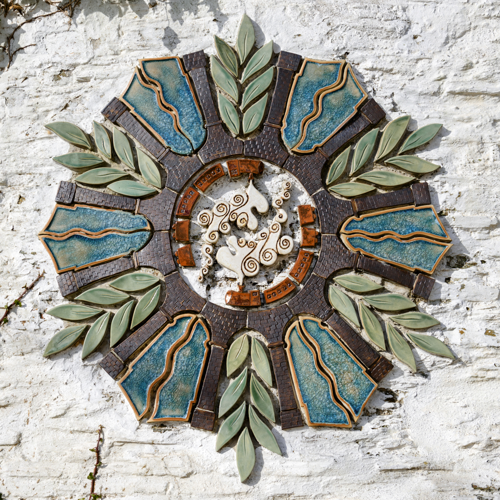 A photo of Ceramic Art by Rose Ferik on the side of a house in Calstock celebrating centenary of the Gunnislake Branchlike